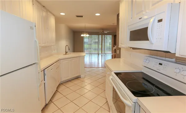 a kitchen with a sink a stove and cabinets