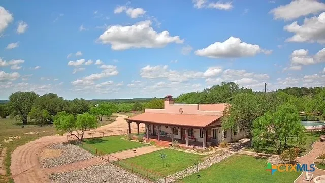 an aerial view of a house with garden space and street view