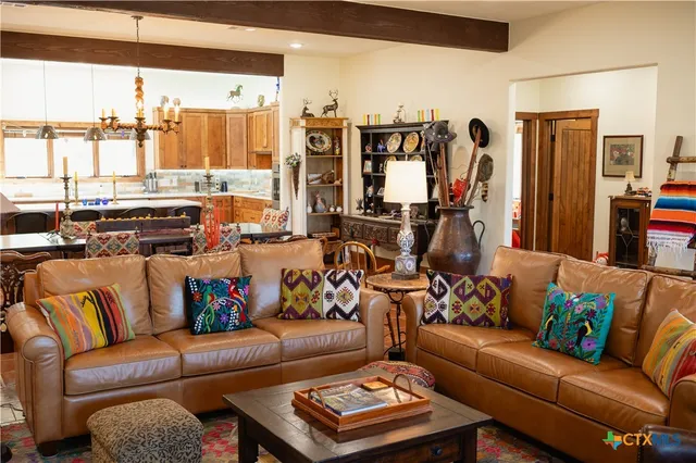 a living room with furniture and a floor to ceiling window