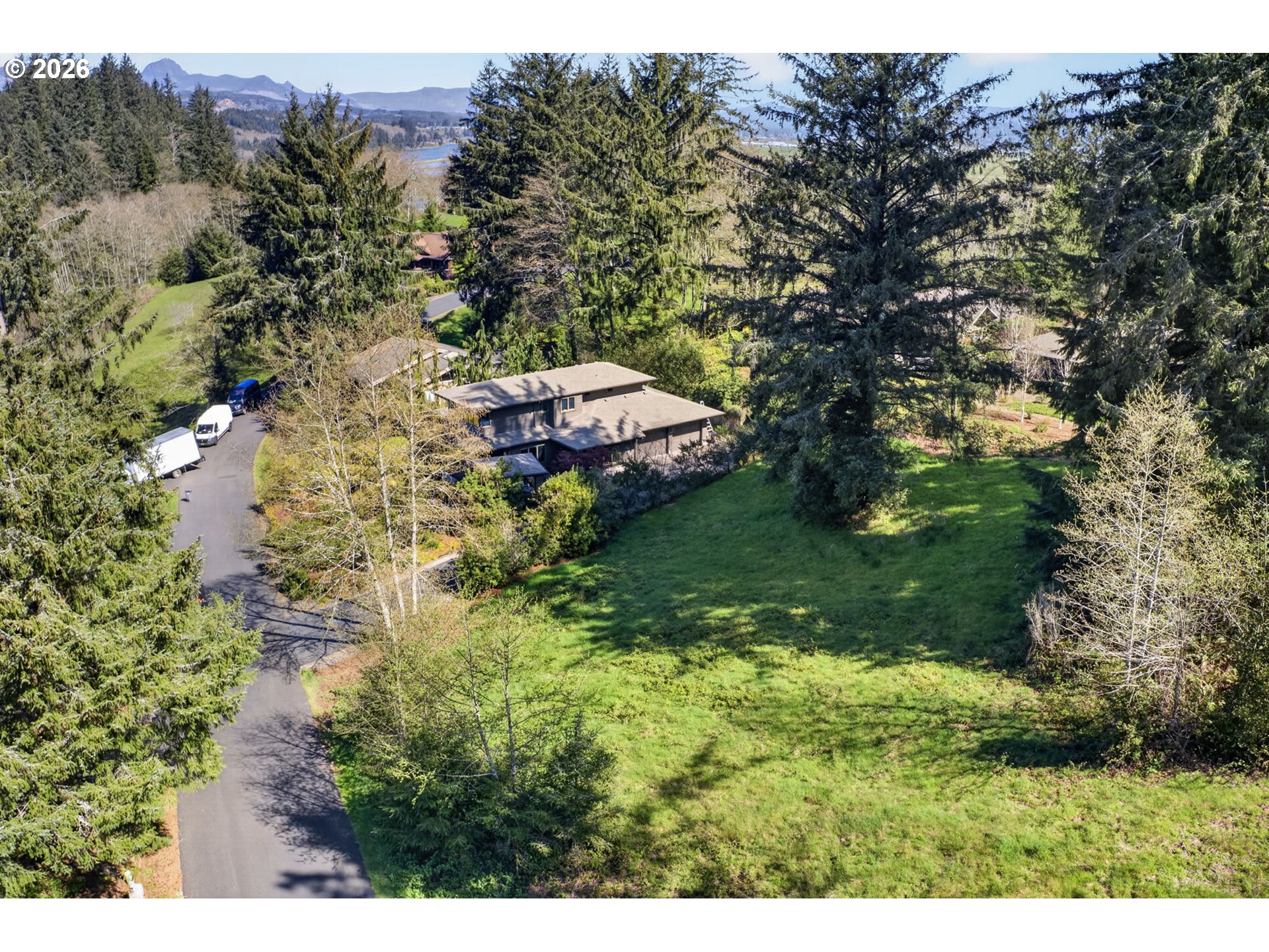 34775 Bay Loop Road Nehalem, OR 97131 - Photo 3 of 10 a backyard of a house with lots of green space