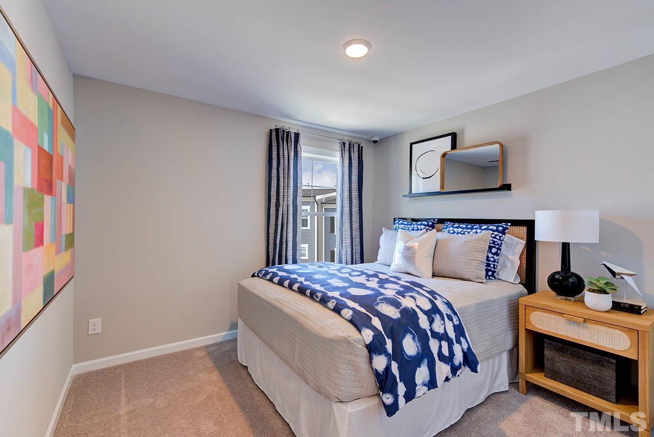 7016 Bent Pine Place, Unit 34 Raleigh, NC 27613 - Photo 19 of 24 a bedroom with a bed and a painting on the wall