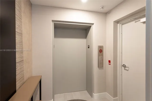 a spacious bedroom with a bed and glass windows