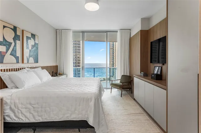 a bathroom with a white tub a sink and mirror