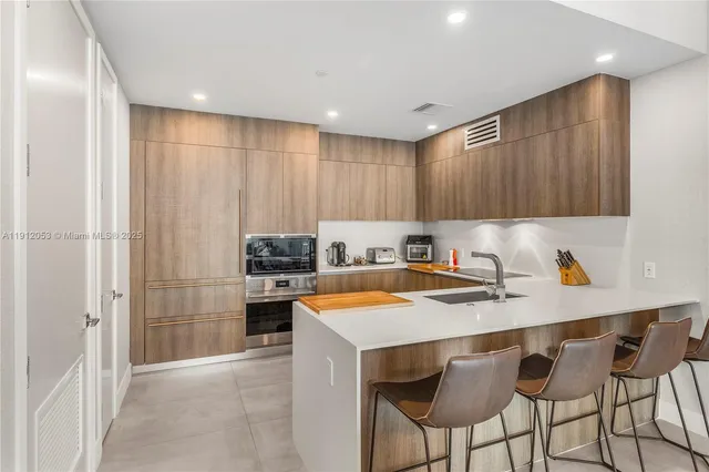 a kitchen with a sink cabinets and stainless steel appliances