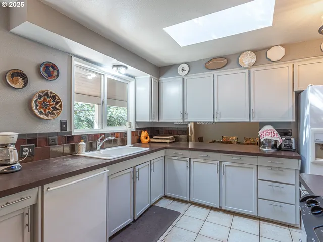 a kitchen with stainless steel appliances granite countertop a sink and a cabinets