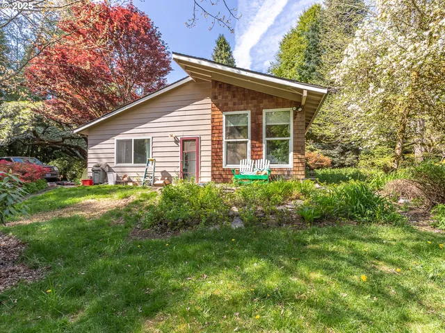 a view of house with backyard
