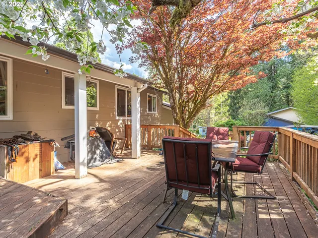 a view of a patio with table and chairs and wooden floor