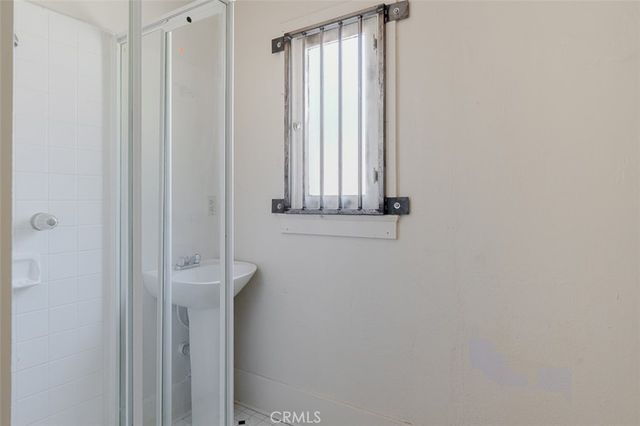 a spacious bathroom with a granite countertop sink mirror and cabinets