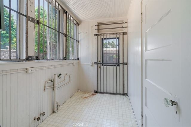 a large white kitchen with a sink and dishwasher a stove top oven with wooden floor