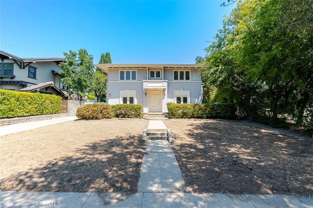 a front view of a house with a yard and a garage