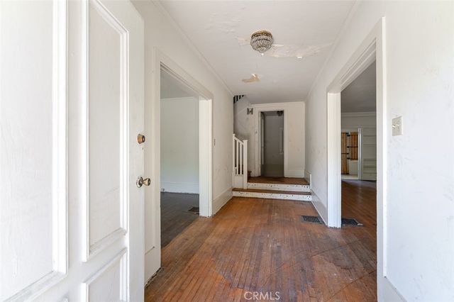 a view of hallway with wooden floor