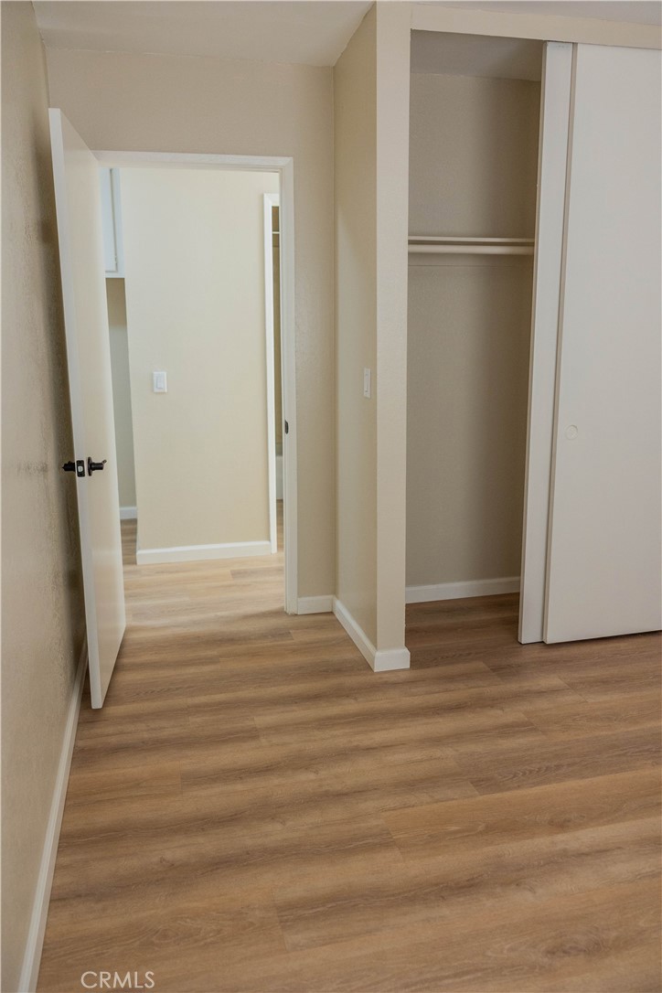 1219 Edwards Street, Unit 33 Redlands, CA 92374 - Photo 21 of 55 a view of a closet area with hardwood floor
