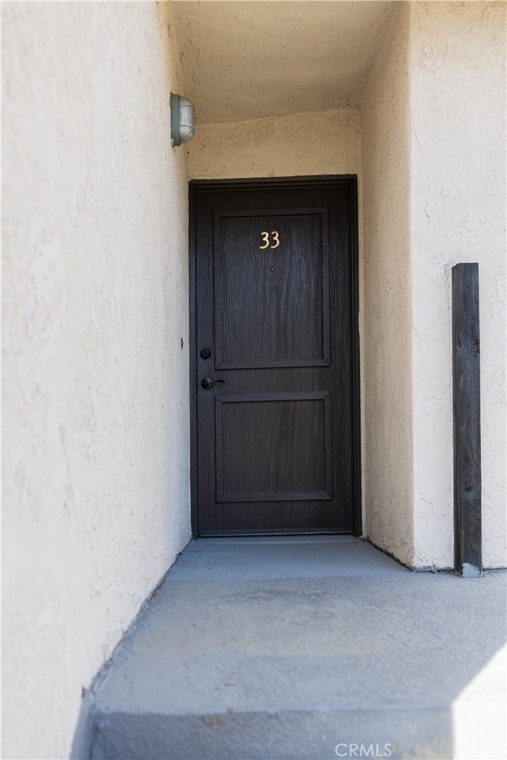 1219 Edwards Street, Unit 33 Redlands, CA 92374 - Photo 3 of 55 a view of wooden door