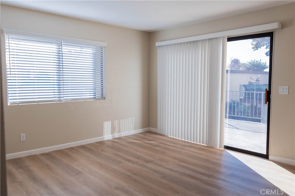 1219 Edwards Street, Unit 33 Redlands, CA 92374 - Photo 6 of 55 an empty room with wooden floor and windows