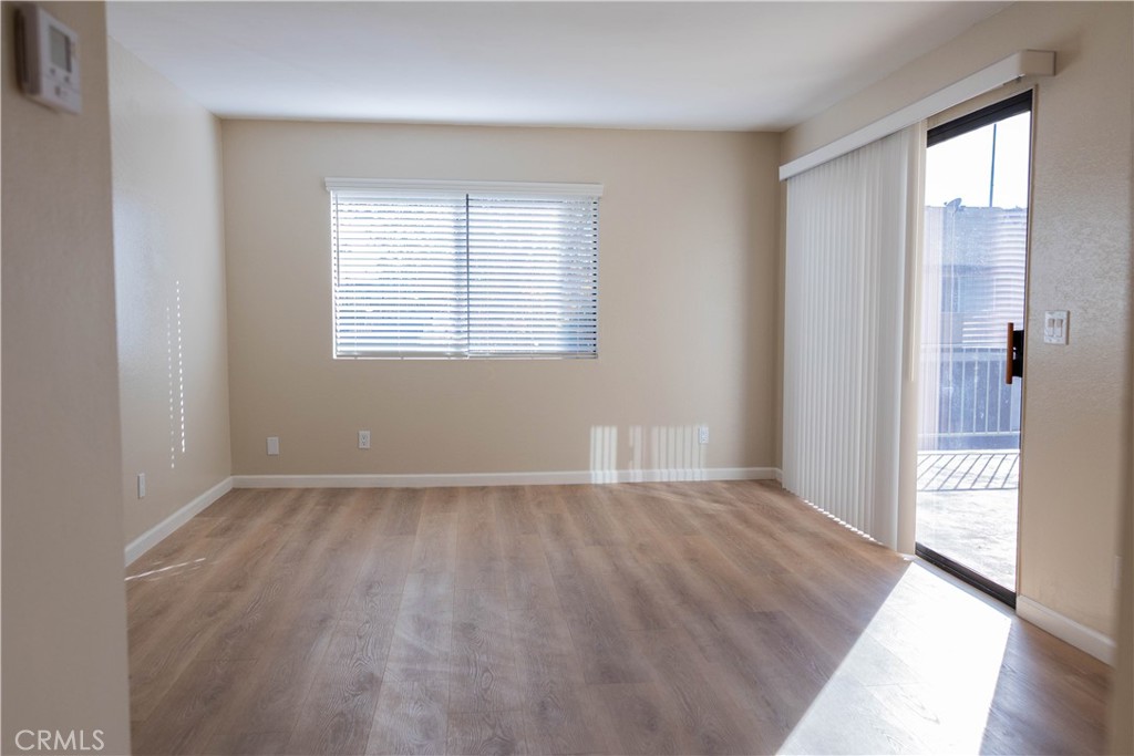 1219 Edwards Street, Unit 33 Redlands, CA 92374 - Photo 7 of 55 an empty room with window and wooden floor