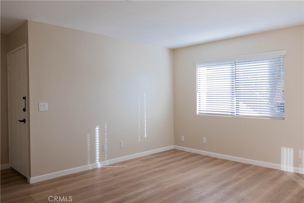1219 Edwards Street, Unit 33 Redlands, CA 92374 - Photo 8 of 55 an empty room with wooden floor and windows