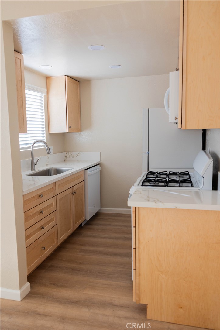 1219 Edwards Street, Unit 33 Redlands, CA 92374 - Photo 9 of 55 a kitchen with sink a stove and white cabinets