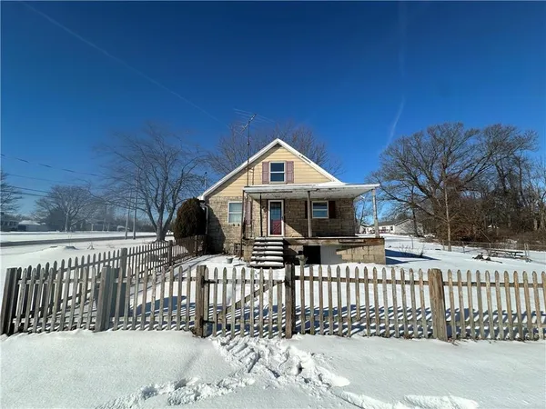a front view of a house with a fence