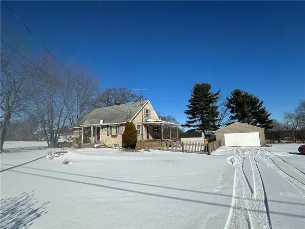 a view of a house with a snow on the road