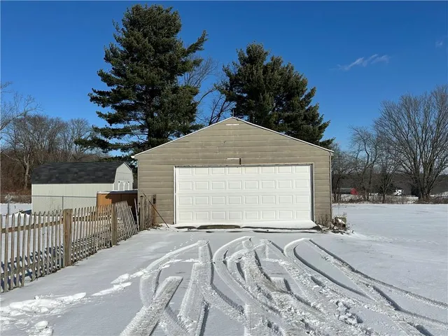 a view of a backyard with a snow on the road