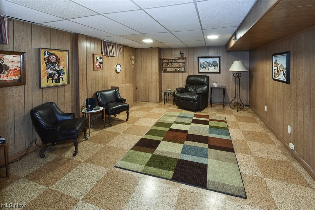4026 Stonehaven Road Cleveland, OH 44121 - Photo 28 of 30 Living area featuring wood walls and a paneled ceiling