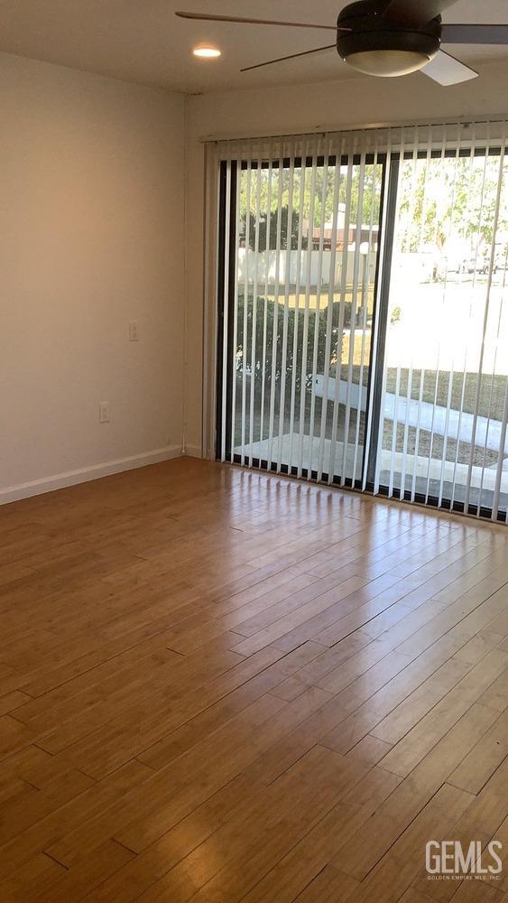 Undisclosed Address Bakersfield, CA 93309 - Photo 11 of 31 a view of an empty room with wooden floor and a window