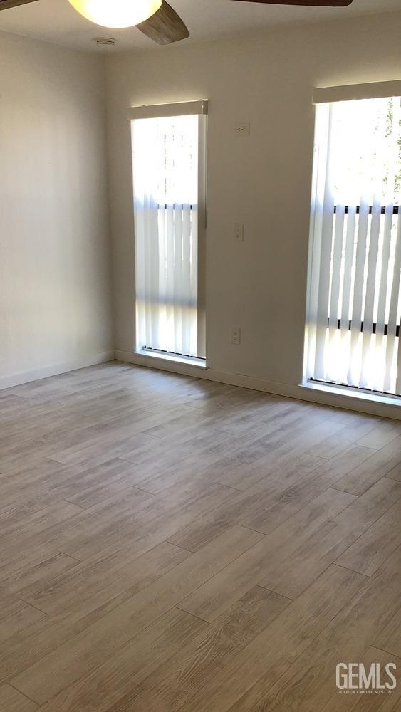 Undisclosed Address Bakersfield, CA 93309 - Photo 15 of 31 a view of an empty room with wooden floor and a window