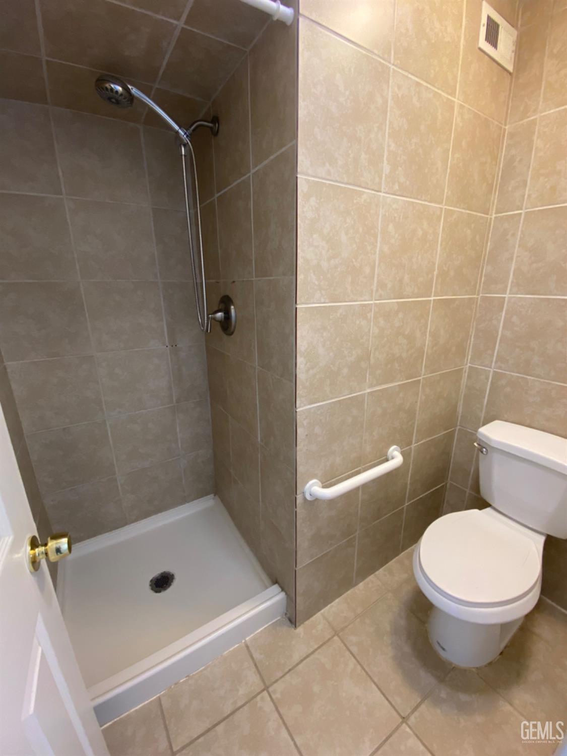 Undisclosed Address Bakersfield, CA 93309 - Photo 18 of 31 a bathroom with a toilet and a shower