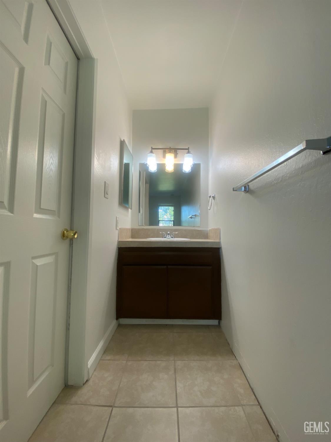 Undisclosed Address Bakersfield, CA 93309 - Photo 21 of 31 a bathroom with a sink and a mirror