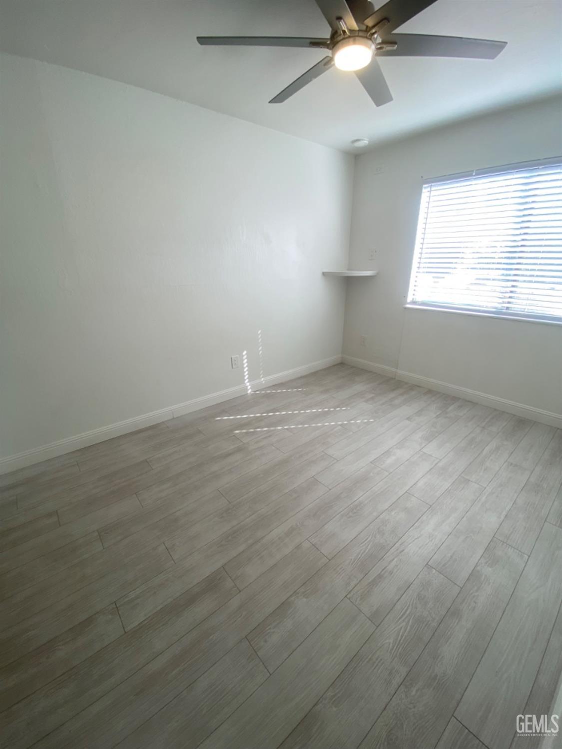 Undisclosed Address Bakersfield, CA 93309 - Photo 25 of 31 an empty room with windows and fan