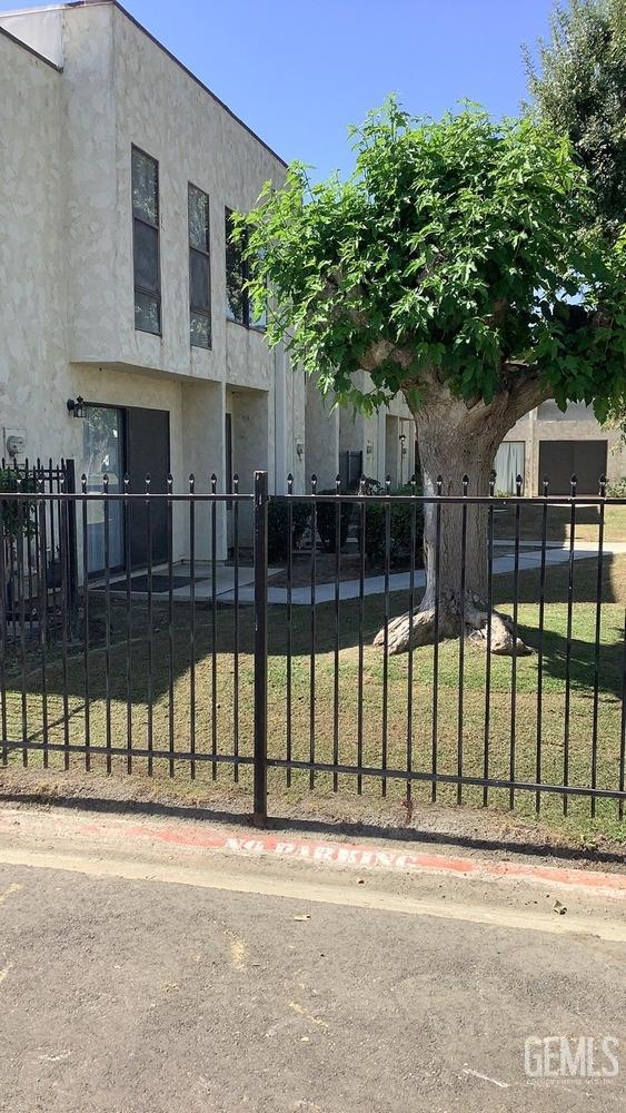 Undisclosed Address Bakersfield, CA 93309 - Photo 4 of 31 a view of a brick house in front of a yard with large tree