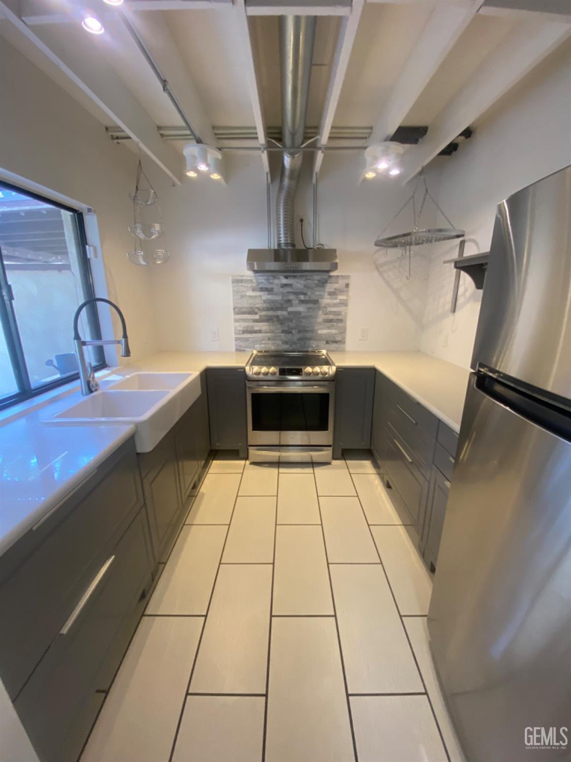 Undisclosed Address Bakersfield, CA 93309 - Photo 5 of 31 a kitchen with stainless steel appliances a sink and cabinets