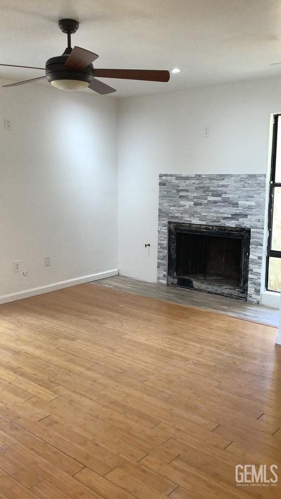 Undisclosed Address Bakersfield, CA 93309 - Photo 10 of 31 a view of an empty room with wooden floor and a fireplace