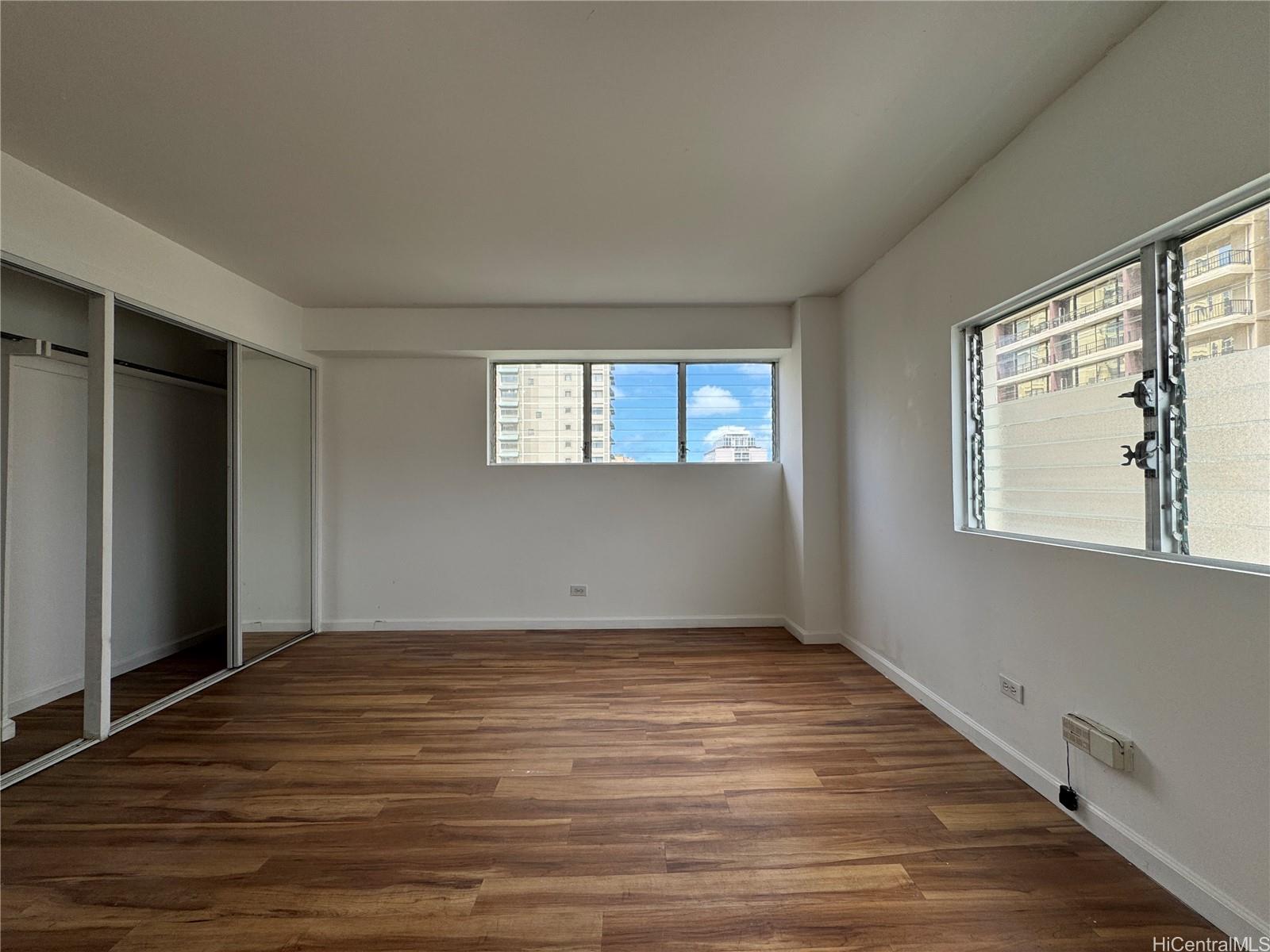 2085 Ala Wai Boulevard, Unit B94 Honolulu, HI 96815 - Photo 11 of 23 a view of an empty room with wooden floor and a window