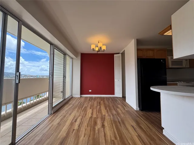 a view of a room with wooden floor and a balcony