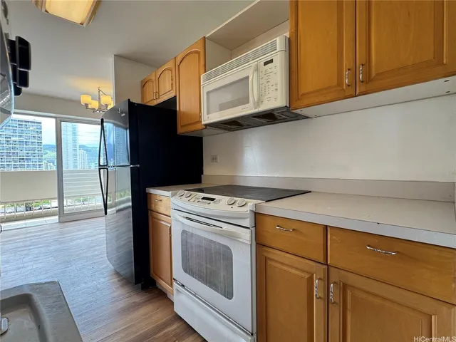 a kitchen with wooden cabinets and a stove top oven