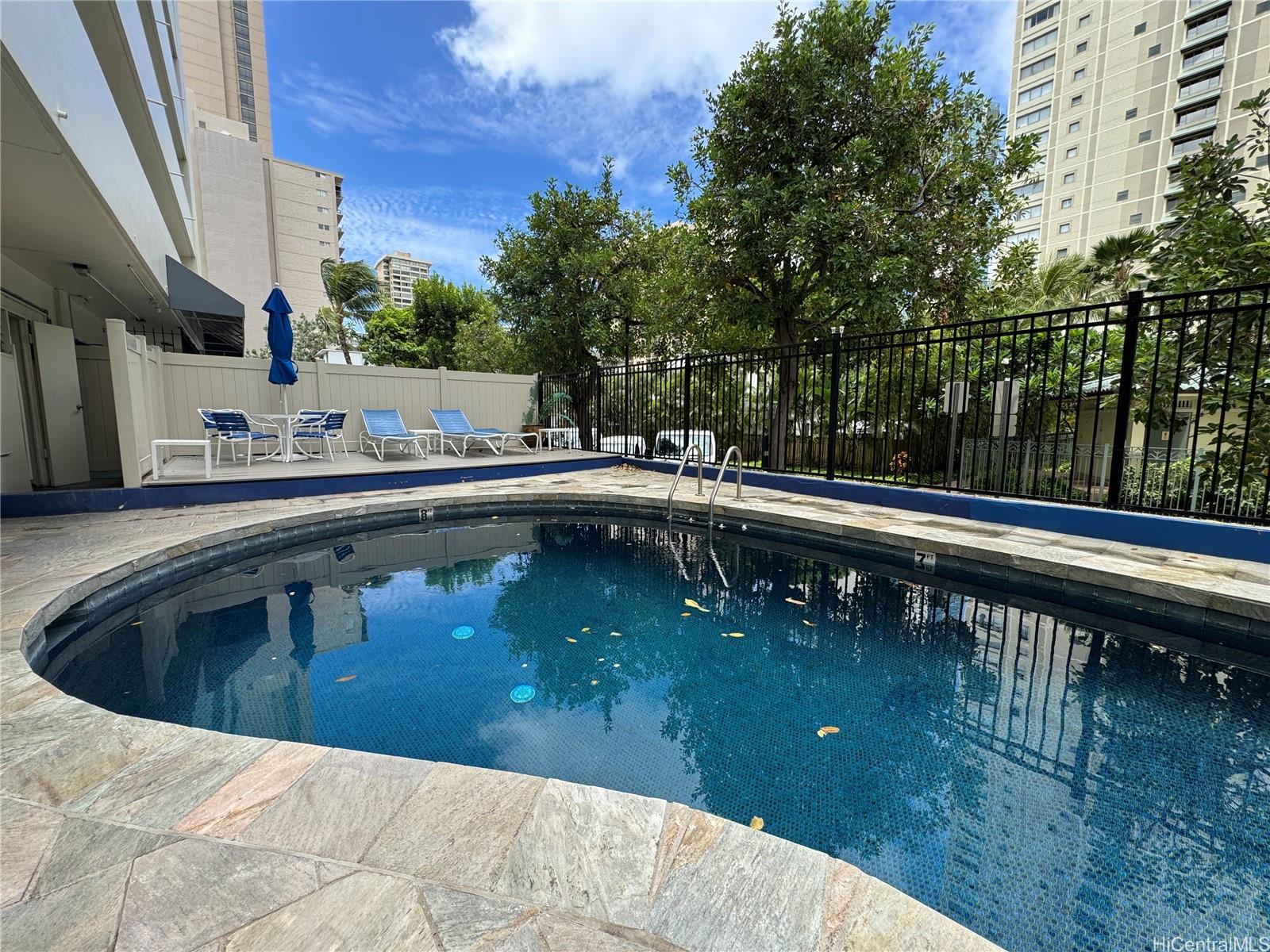 2085 Ala Wai Boulevard, Unit B94 Honolulu, HI 96815 - Photo 23 of 23 a view of a swimming pool with a yard