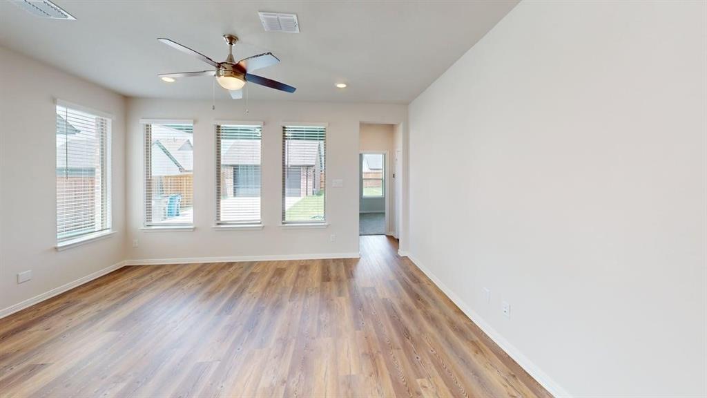 1840 Rosedale Avenue Van Alstyne, TX 75495 - Photo 7 of 24 Spacious room featuring wood-finish flooring, a ceiling fan with integrated lighting, recessed lighting, and multiple windows with blinds