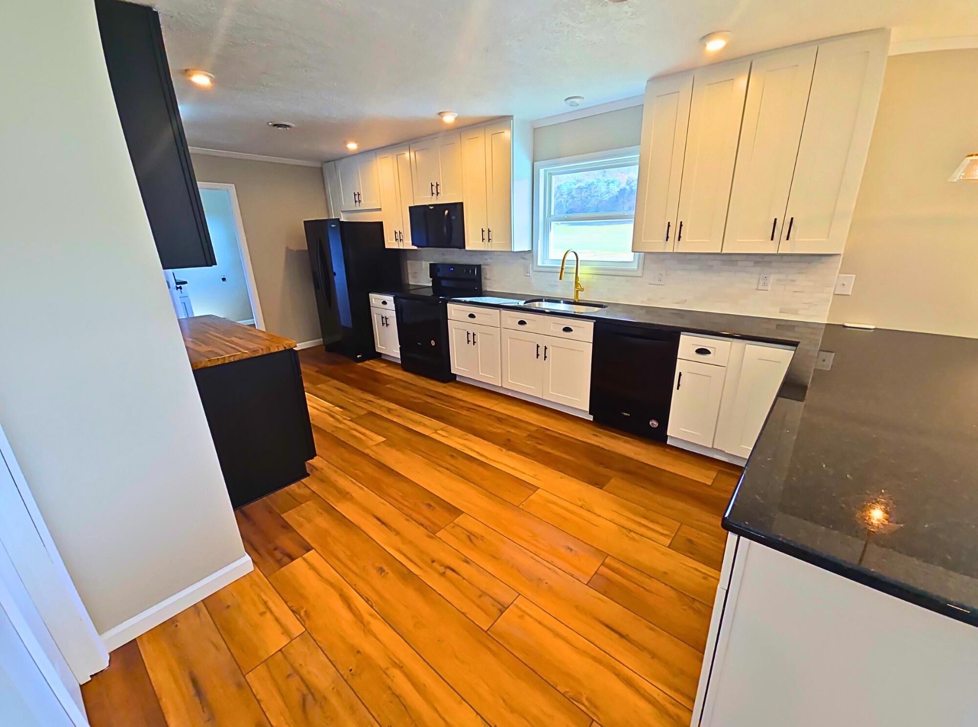 858 Main Street Decatur, TN 37322 - Photo 15 of 47 a kitchen with stainless steel appliances refrigerator sink and cabinets