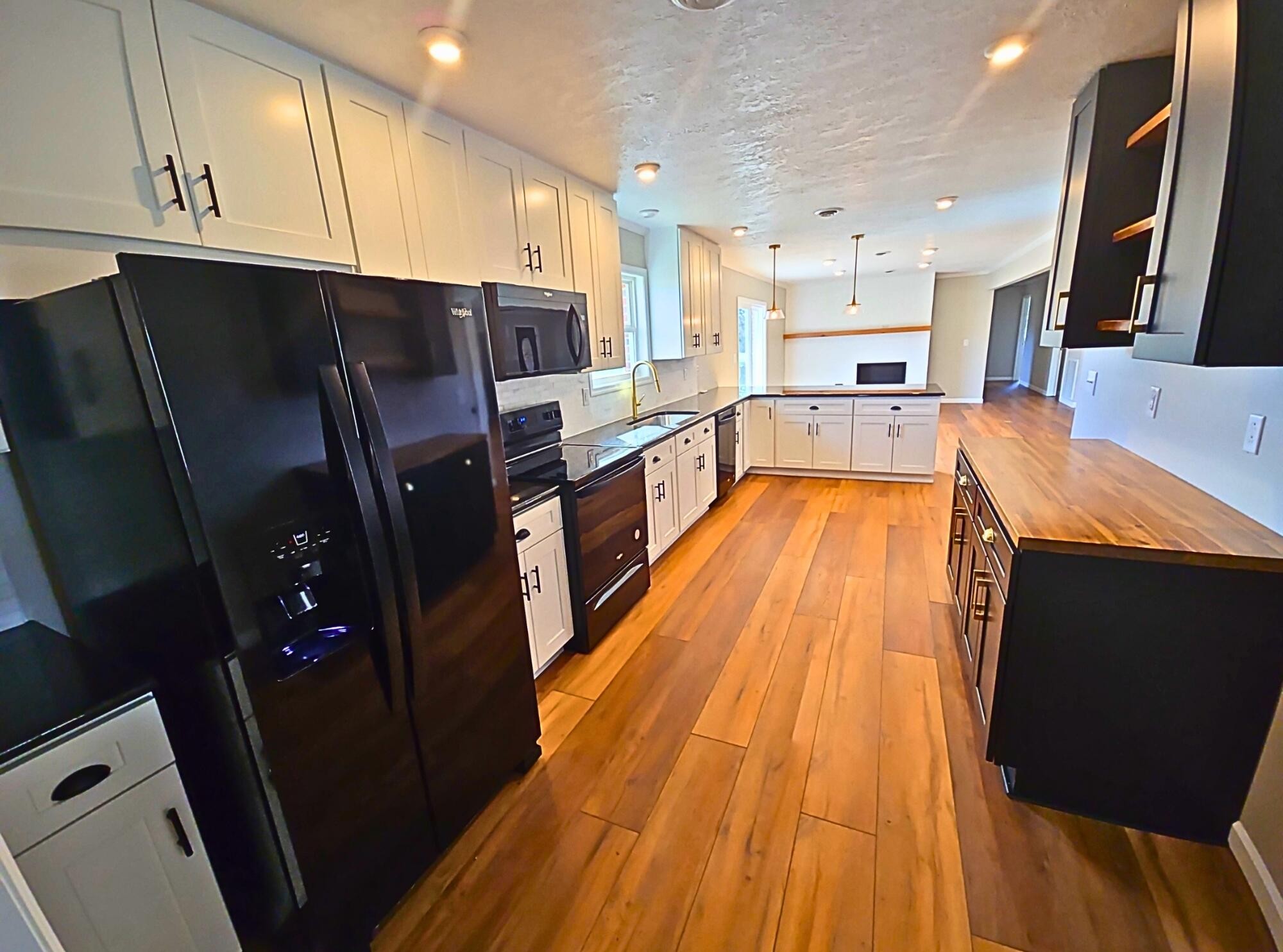 858 Main Street Decatur, TN 37322 - Photo 16 of 47 a large kitchen with stainless steel appliances kitchen island granite countertop wooden floors