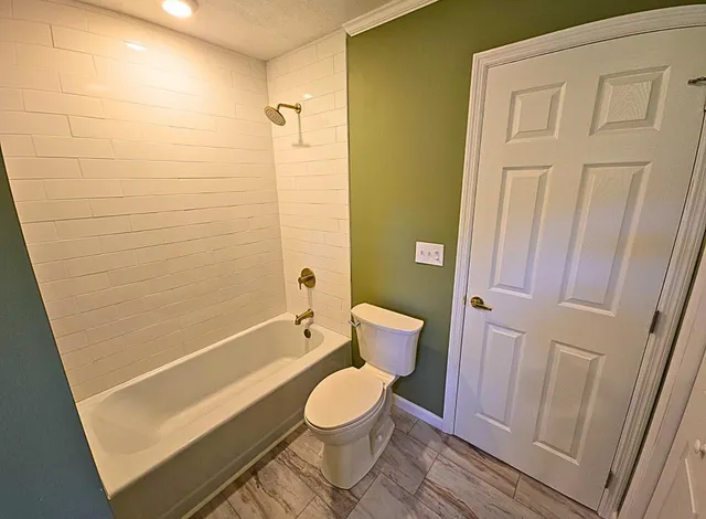 a bathroom with a toilet and a shower