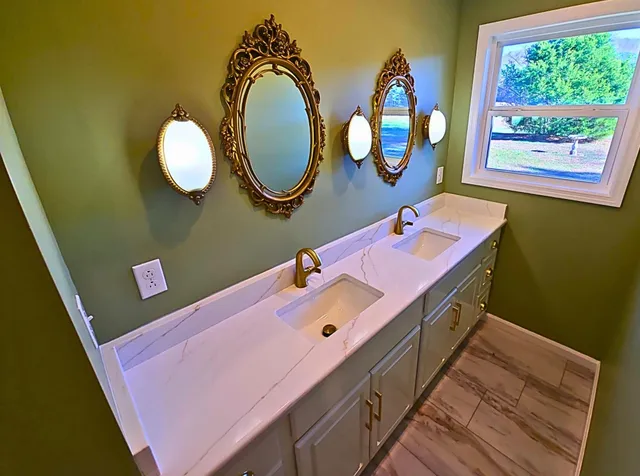 a bathroom with a sink mirror and vanity