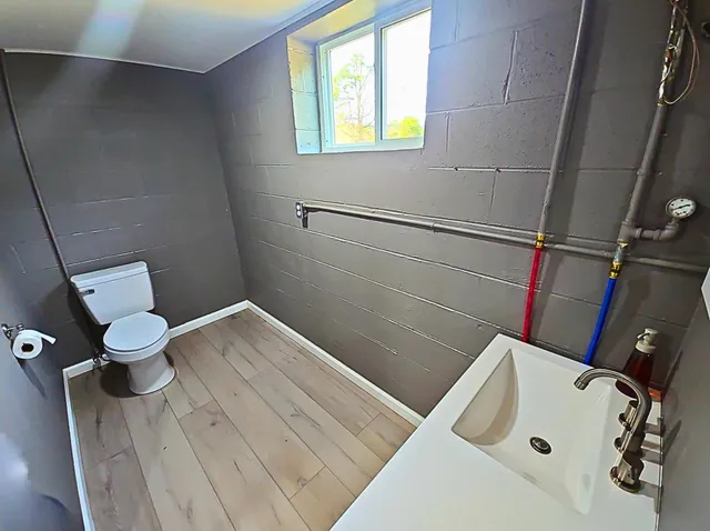 a bathroom with a sink a mirror and a window