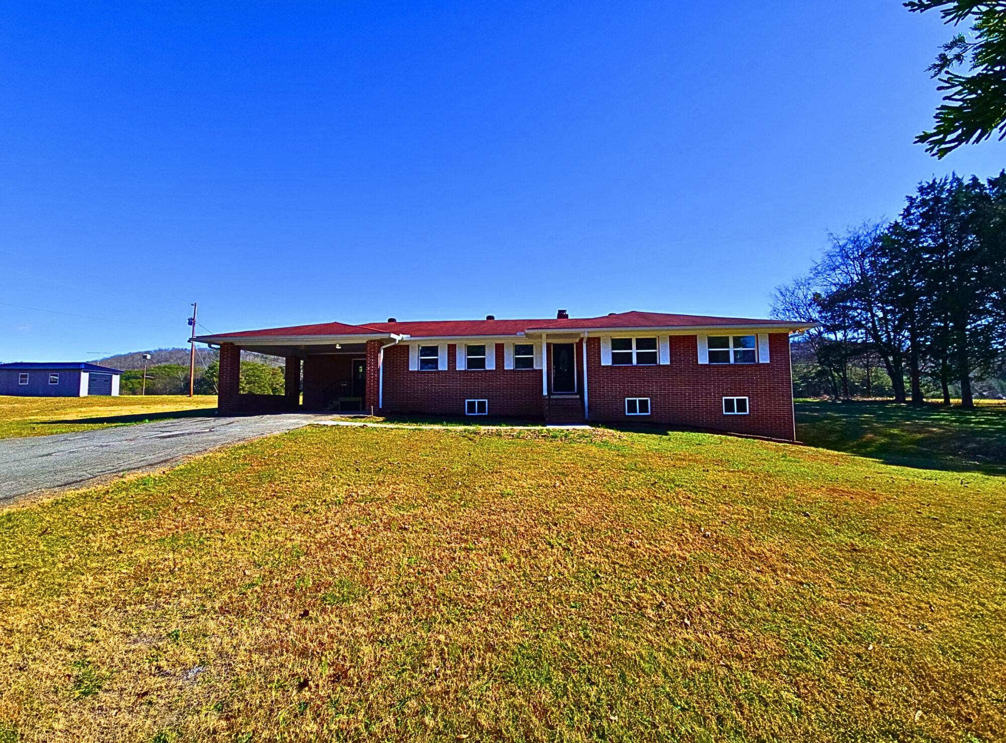 858 Main Street Decatur, TN 37322 - Photo 4 of 47 a front view of a house with a yard