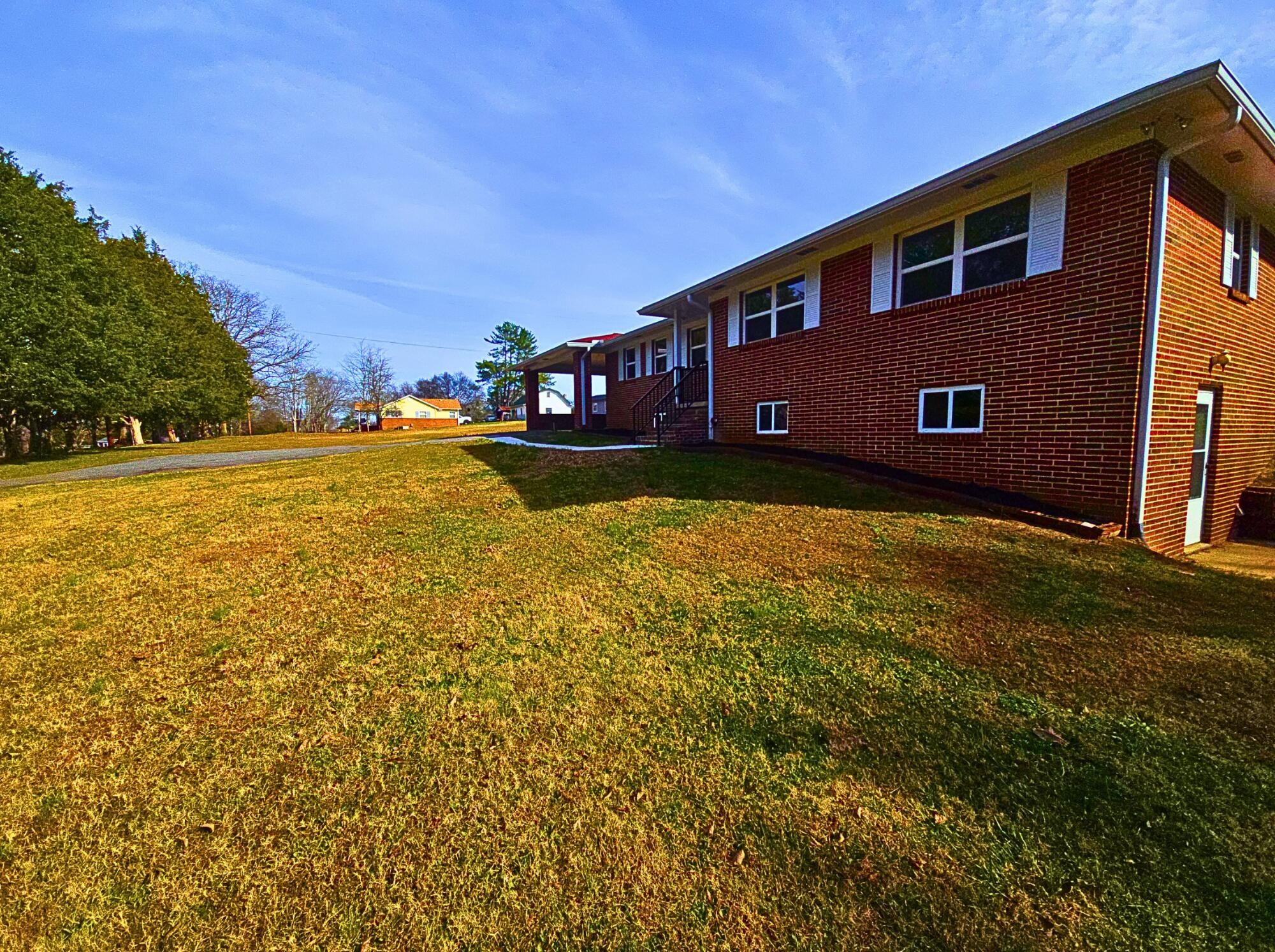 858 Main Street Decatur, TN 37322 - Photo 7 of 47 a front view of house with yard and trees in the background
