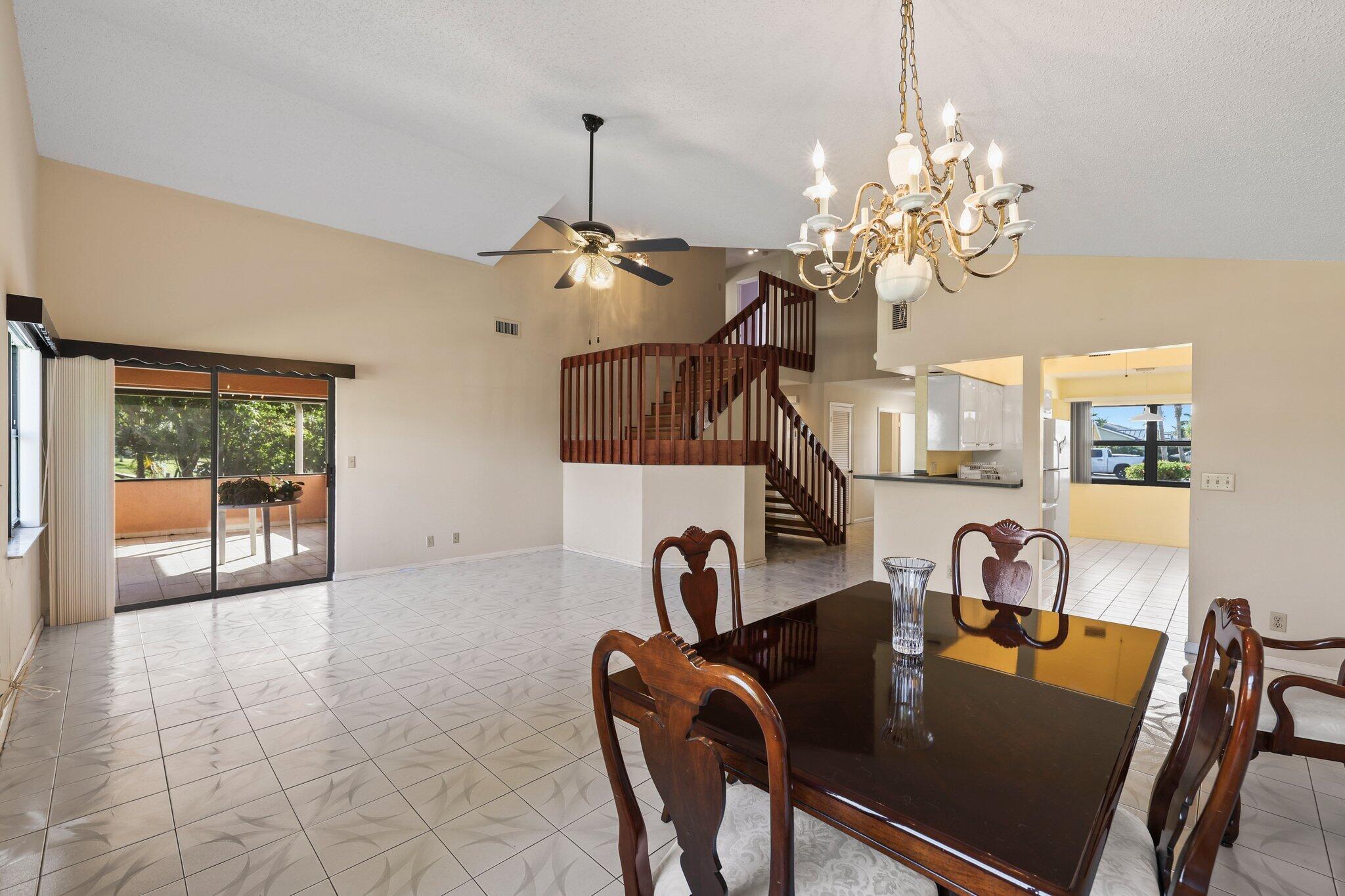 1235 Northwest 19th Terrace Delray Beach, FL 33445 - Photo 11 of 45 a view of a dining room with furniture and chandelier