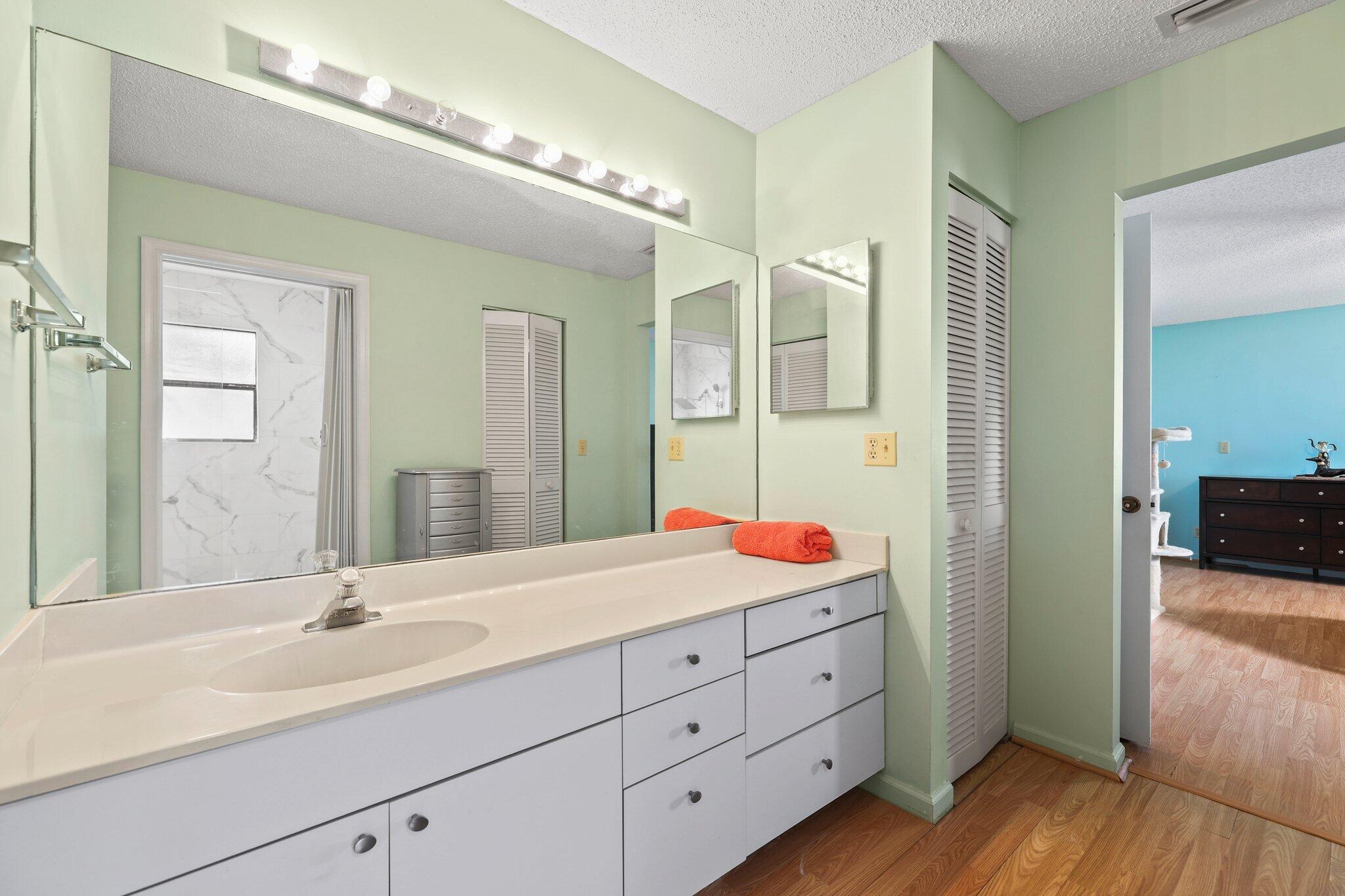 1235 Northwest 19th Terrace Delray Beach, FL 33445 - Photo 16 of 45 a en suite bathroom with double sink and a mirror