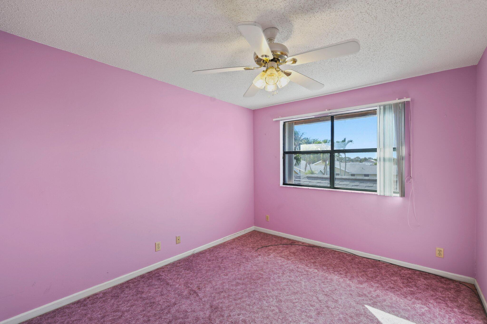 1235 Northwest 19th Terrace Delray Beach, FL 33445 - Photo 20 of 45 a view of an empty room with chandelier fan and wooden floor