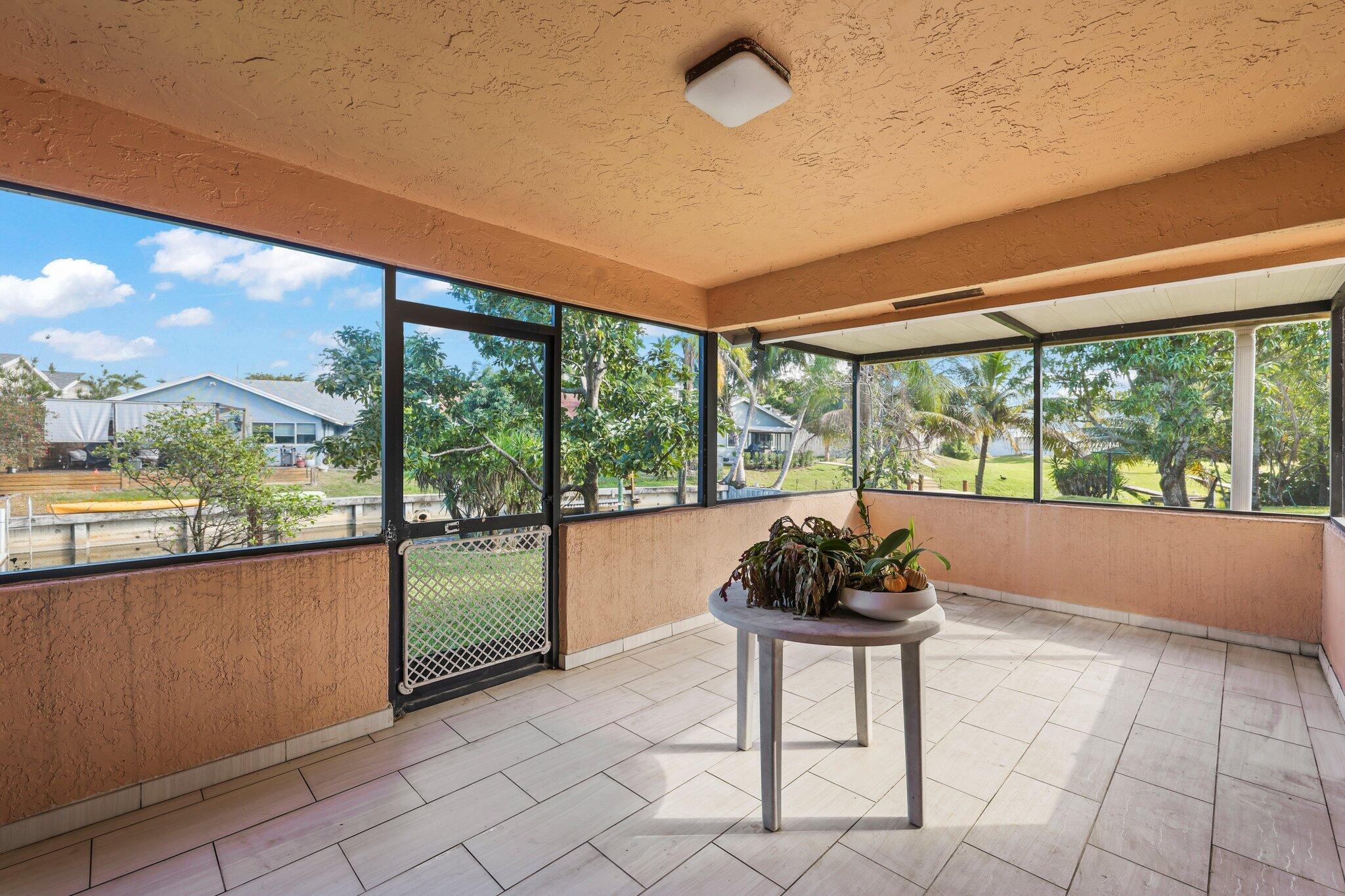 1235 Northwest 19th Terrace Delray Beach, FL 33445 - Photo 22 of 45 a living room with furniture and a large window