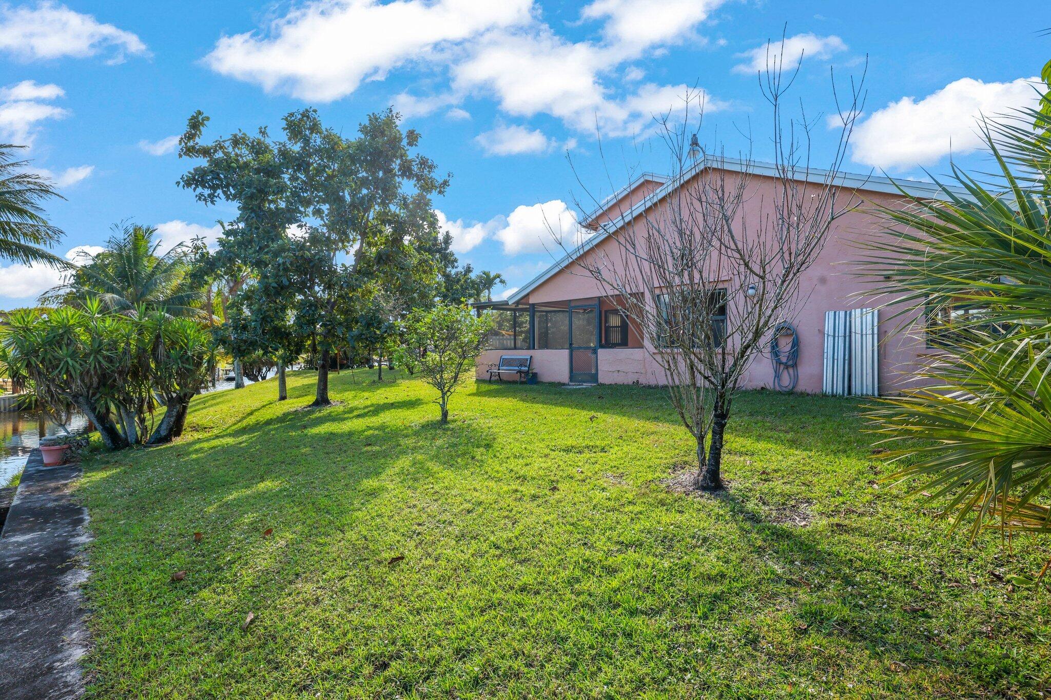 1235 Northwest 19th Terrace Delray Beach, FL 33445 - Photo 25 of 45 a view of a house with a backyard